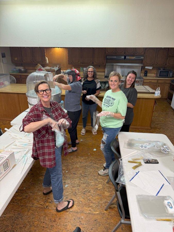 Having fun while bagging cotton candy in the church kitchen